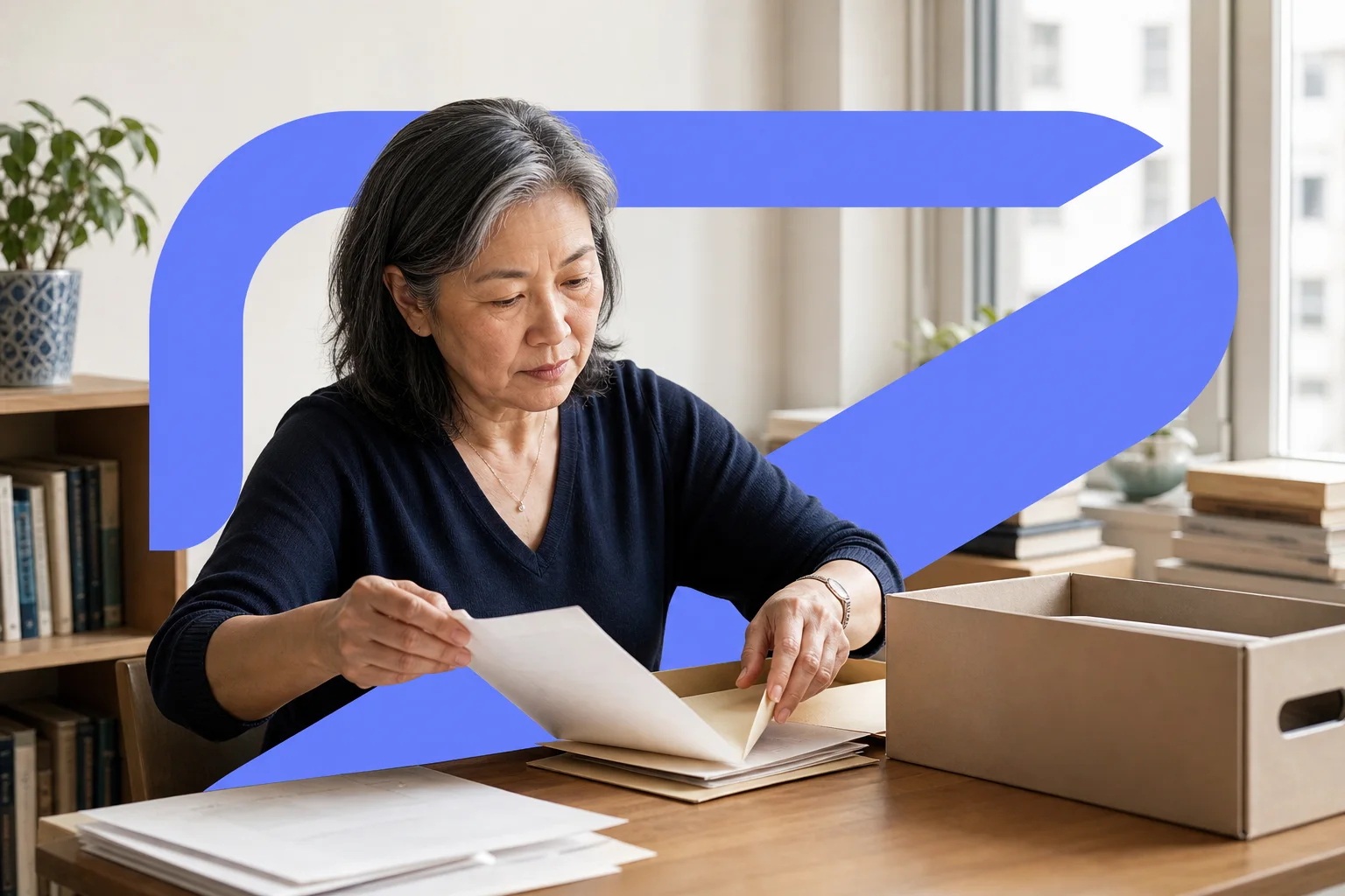 A woman organising household records after a move